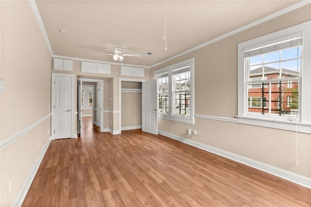 unfurnished bedroom featuring ceiling fan, a closet, ornamental molding, and hardwood / wood-style flooring