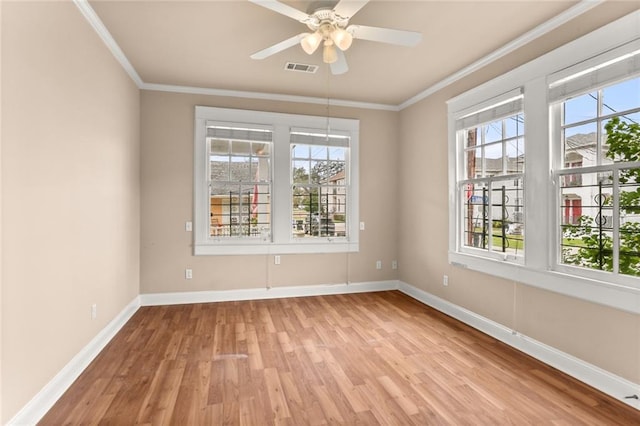 unfurnished room with ceiling fan, a wealth of natural light, ornamental molding, and light hardwood / wood-style floors