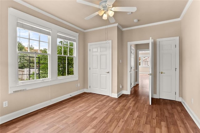 unfurnished bedroom with ceiling fan, crown molding, and hardwood / wood-style floors