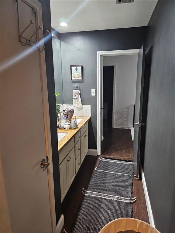 bathroom featuring wood-type flooring and vanity