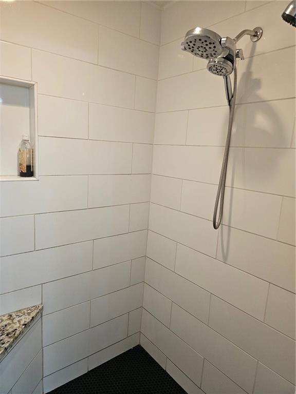 bathroom with a tile shower