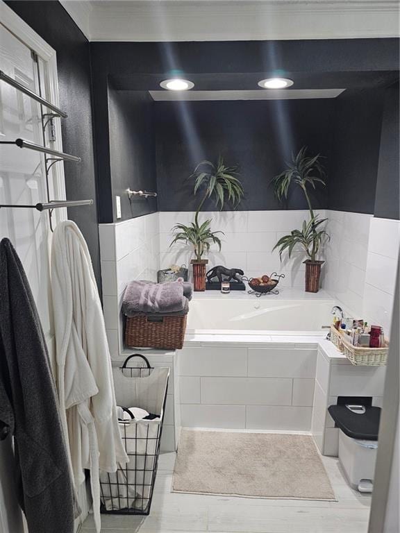 bathroom featuring tile patterned floors and tiled bath