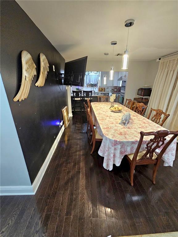 dining room with dark hardwood / wood-style flooring