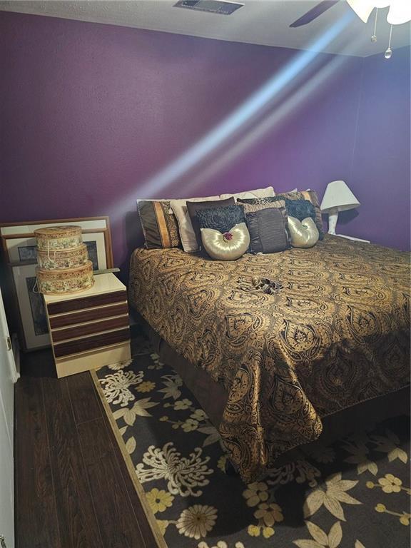 bedroom featuring ceiling fan and wood-type flooring