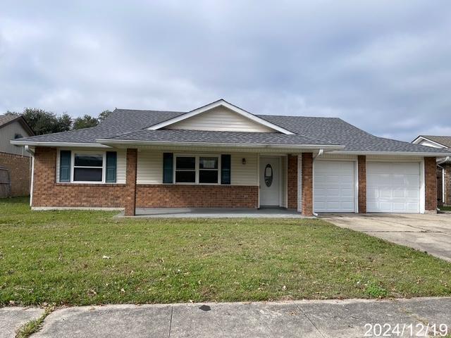 ranch-style home with covered porch, a garage, and a front lawn