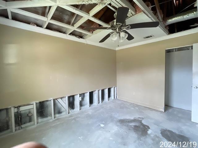 interior space with concrete floors and ceiling fan