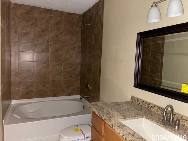1809 W Frisco Dr, La Place, LA 70068 - full bathroom with vanity, tiled shower / bath combo, and toilet