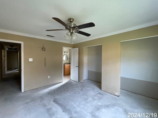 1809 W Frisco Dr, La Place, LA 70068 - unfurnished bedroom featuring ceiling fan, ornamental molding, and ensuite bath