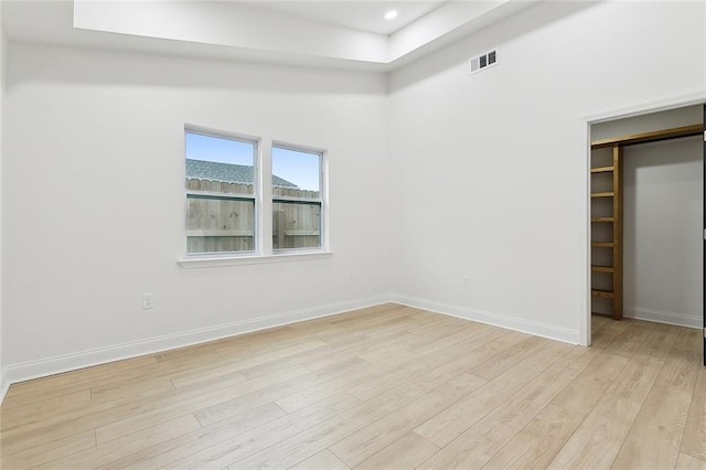 unfurnished bedroom with a closet and light hardwood / wood-style flooring