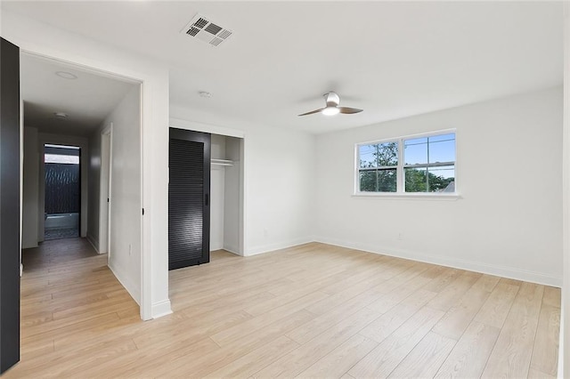 unfurnished bedroom with a closet, ceiling fan, and light hardwood / wood-style flooring