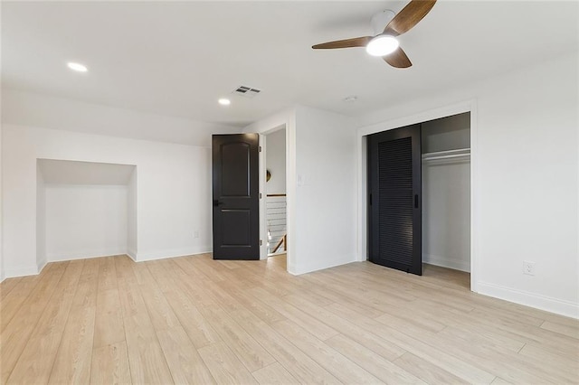 unfurnished bedroom with light wood-type flooring, a closet, and ceiling fan