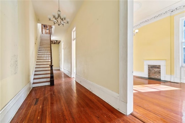1432 Magazine St, New Orleans, LA 70130 - hallway featuring a chandelier and wood-type flooring