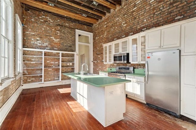 1432 Magazine St, New Orleans, LA 70130 - kitchen featuring white cabinets, sink, an island with sink, and appliances with stainless steel finishes