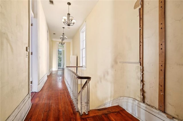 1432 Magazine St, New Orleans, LA 70130 - hall with dark hardwood / wood-style flooring and a notable chandelier