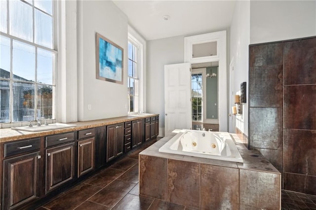 1432 Magazine St, New Orleans, LA 70130 - bathroom with vanity, tile patterned flooring, a relaxing tiled tub, and a healthy amount of sunlight