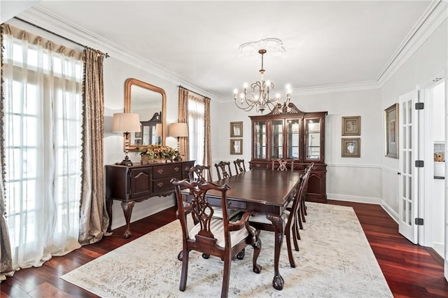 dining area featuring crown molding, plenty of natural light, dark hardwood / wood-style floors, and a chandelier