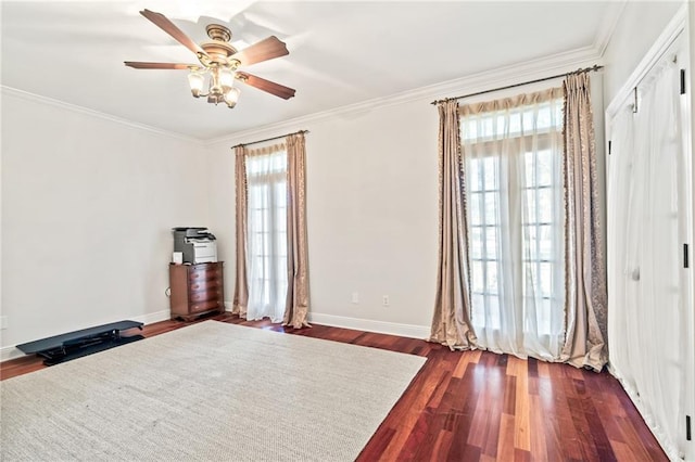 unfurnished bedroom with multiple windows, dark wood-type flooring, ornamental molding, and a closet