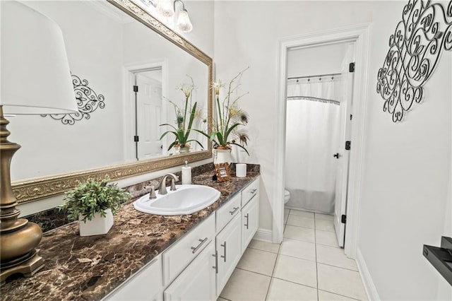 bathroom featuring vanity, tile patterned floors, and toilet