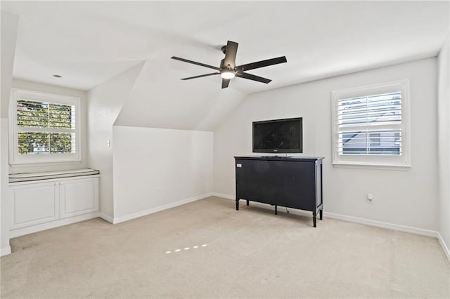 bonus room with ceiling fan, light colored carpet, and vaulted ceiling