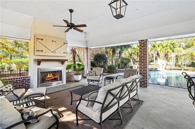 view of patio featuring a fenced in pool and an outdoor living space with a fireplace