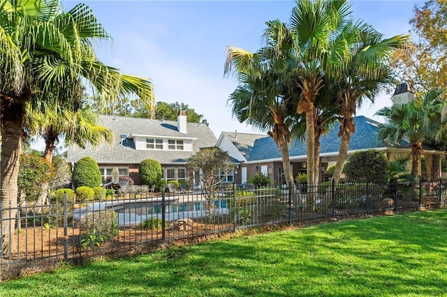 view of pool featuring a lawn and a patio