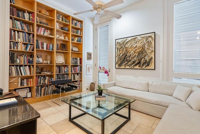 sitting room featuring ceiling fan, light tile patterned flooring, and a healthy amount of sunlight