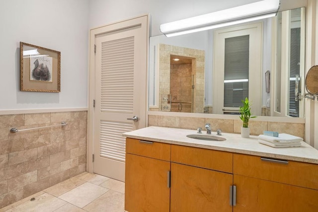 bathroom featuring tile patterned flooring, vanity, and tile walls