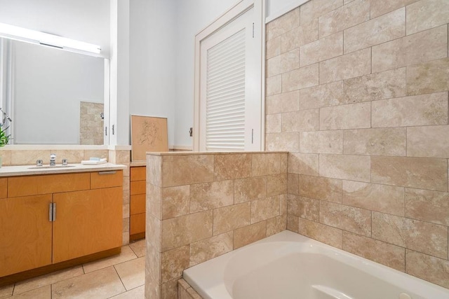 bathroom with tile patterned flooring, vanity, and a tub to relax in