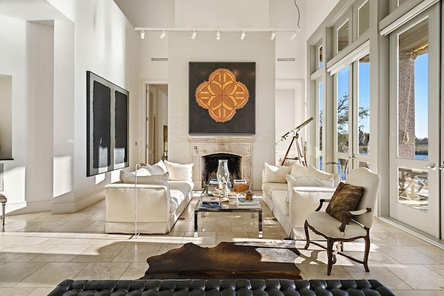 living room featuring light tile patterned floors and track lighting