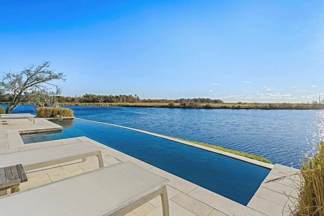 exterior space featuring a patio area and a water view