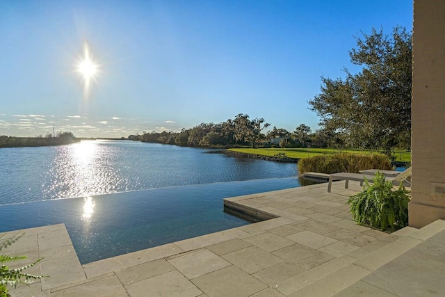 exterior space featuring a patio area and a water view