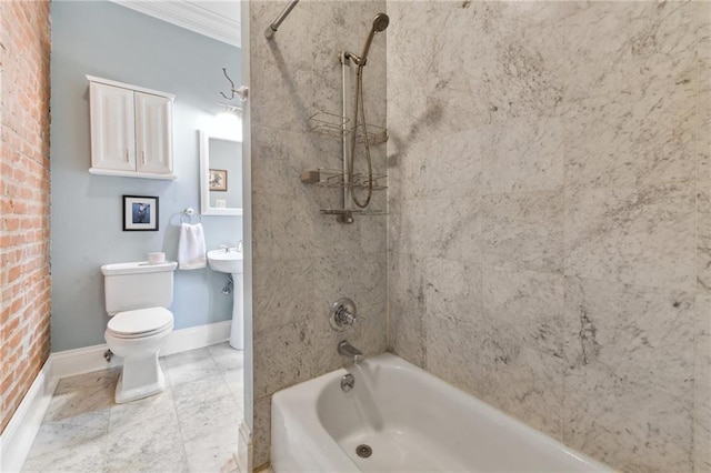 bathroom featuring ornamental molding, tiled shower / bath combo, and toilet