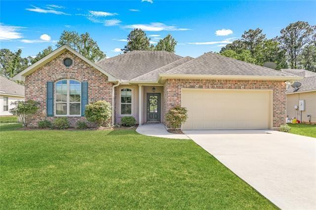 ranch-style home with a garage and a front yard