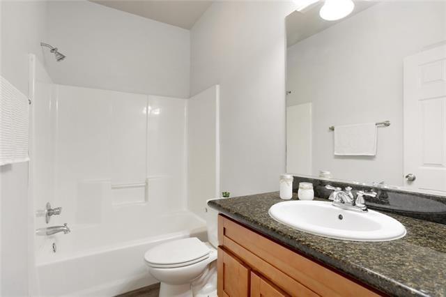 full bathroom with shower / tub combination, vanity, and toilet