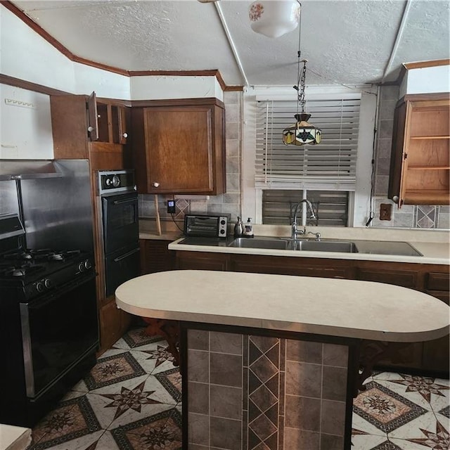 kitchen featuring black range with gas stovetop, a textured ceiling, crown molding, and sink