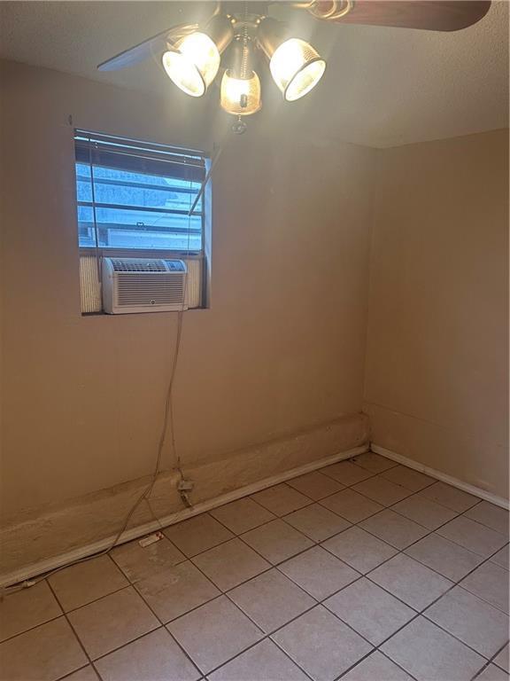 spare room with cooling unit and light tile patterned floors