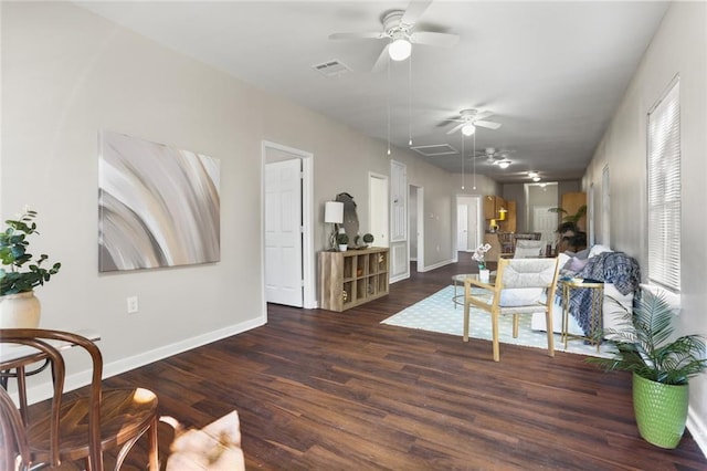 living room featuring ceiling fan, a wealth of natural light, and dark hardwood / wood-style flooring