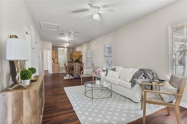 living room with dark wood-type flooring and ceiling fan