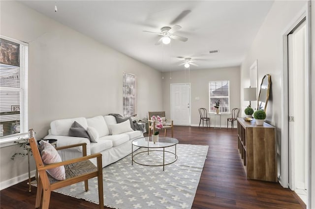 living room featuring ceiling fan and dark hardwood / wood-style flooring