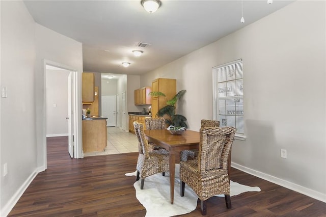 dining space with dark hardwood / wood-style floors