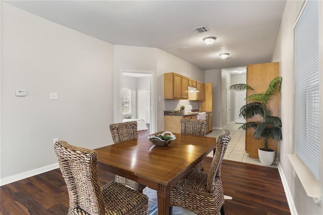 dining space with wood-type flooring