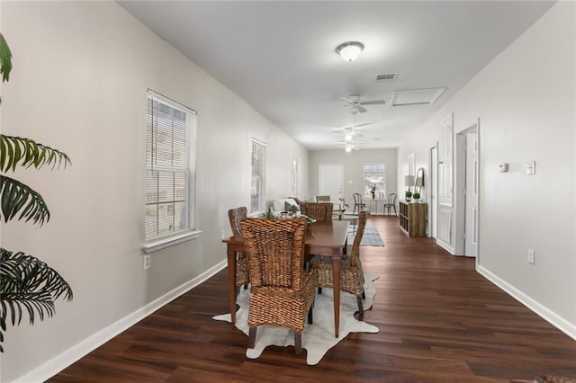 dining space with ceiling fan and dark wood-type flooring