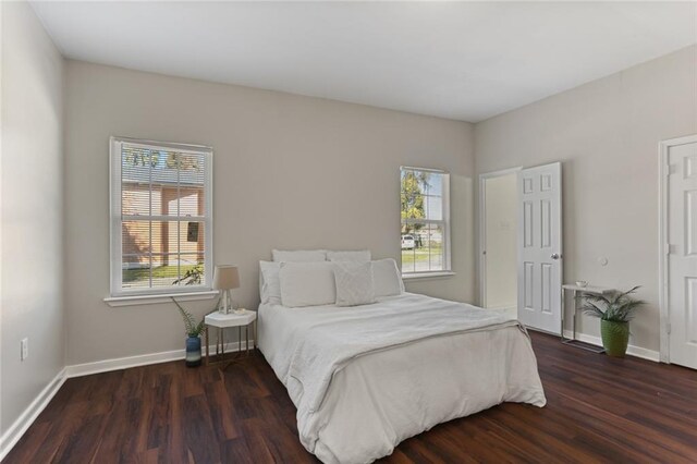 bedroom with dark wood-type flooring