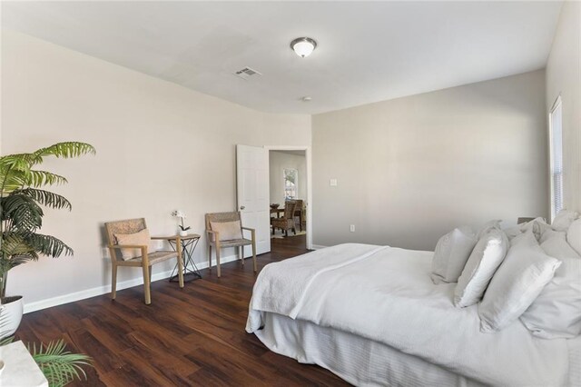 bedroom with dark hardwood / wood-style floors