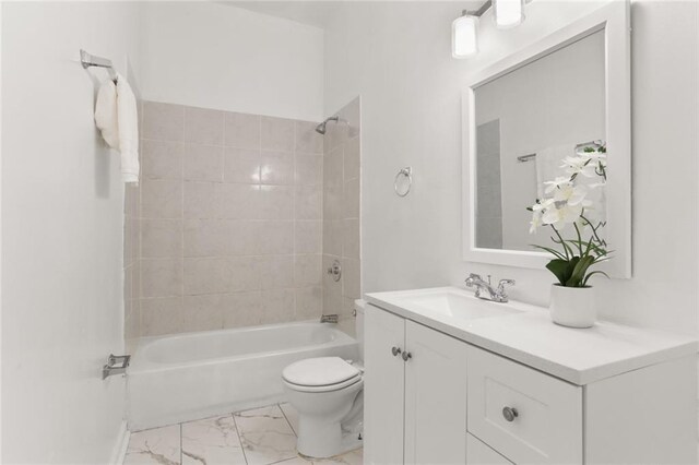 full bathroom with toilet, vanity, and tiled shower / bath