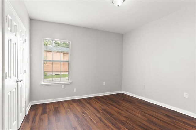 unfurnished bedroom featuring dark hardwood / wood-style floors