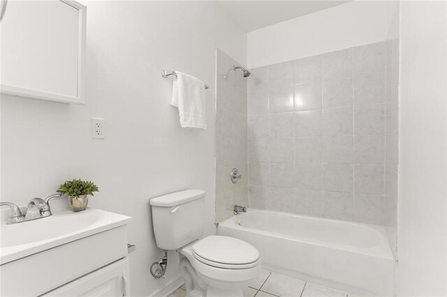 full bathroom featuring toilet, vanity, tile patterned flooring, and tiled shower / bath combo