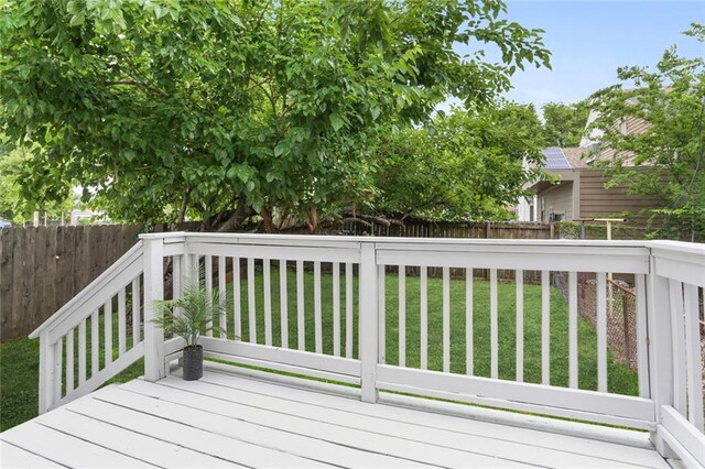 wooden deck with a lawn