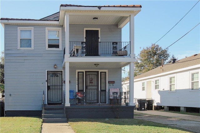 view of front facade featuring a balcony and a porch