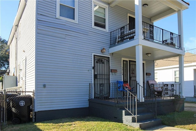 back of property with a porch